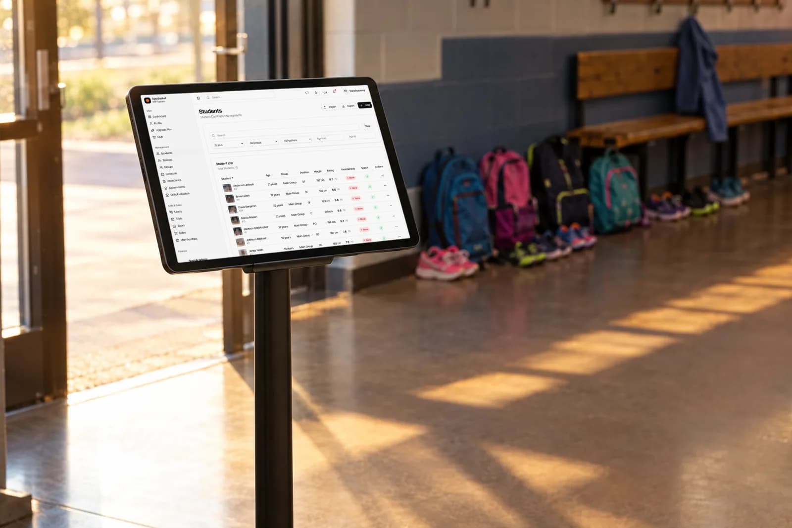 Coach taking attendance at basketball practice with the SpotBasket sports attendance tracking app